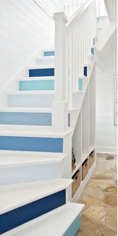 there is a blue and white staircase in this house with stone flooring on both sides