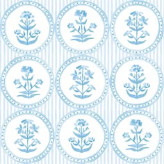 blue and white flowers are arranged in the shape of circles on a striped wallpaper