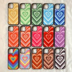 twelve iphone cases with hearts on them are lined up in different colors and sizes,