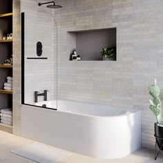 a white bath tub sitting next to a shelf filled with towels