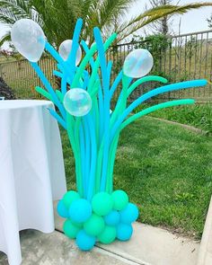 blue balloons are in the shape of flowers