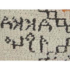 an old rug with black and white letters on it