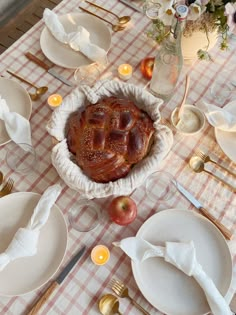 a table set with plates, silverware and an apple pie