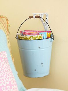 a blue bucket with magazines in it