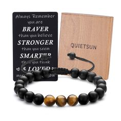 a wooden book and bracelet with black onyx beads