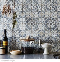 the kitchen counter is covered with spices and condiments, including an olive tree