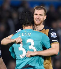 two soccer players hugging each other on the field