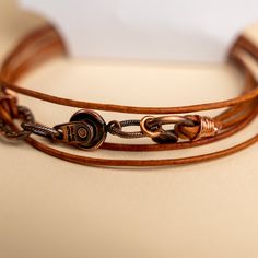 Approx. 14" Handmade in Laurel, Mississippi Beautifully colored natural brown leather with Novi's signature clasp allowing it to snap together with other NoVi bracelets for an original look. Wraps around the wrist twice, or can be worn as a choker. For a looser fit, add an extender! Everyday Hand Wrapped Brown Bracelets, Novi Brown, Laurel Mississippi, Brown Leather Bracelet, Natural Brown, Mississippi, Leather Bracelet, Choker, Brown Leather