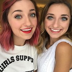 two girls with pink hair and blue eyes are posing for the camera, one is wearing a t - shirt that says girls support