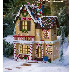 a gingerbread house is decorated with candy canes