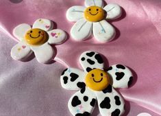 three decorated buttons with smiley faces on them