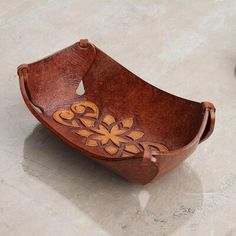 a wooden bowl sitting on top of a table