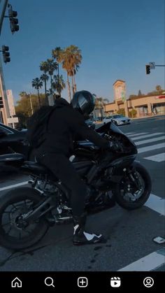 a man riding on the back of a black motorcycle