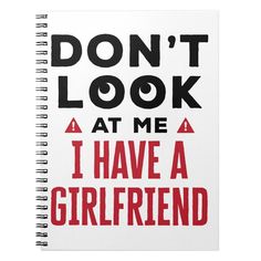 a spiral notebook with the words don't look at me i have a girlfriend