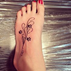 a woman's foot with a flower tattoo on it