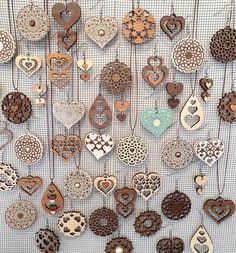 a bunch of wooden hearts hanging on a wall