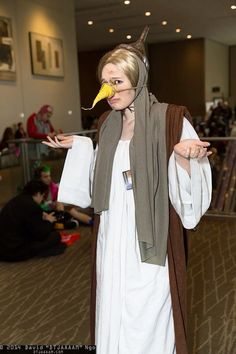 a woman dressed in costume with a bird on her head and scarf around her neck