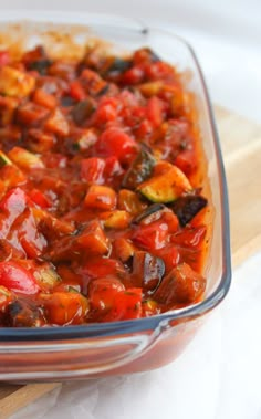 a glass casserole dish filled with vegetables and sauce