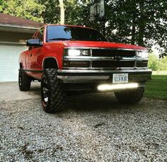 a red truck parked in front of a house