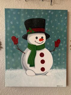 a painting of a snowman wearing a black hat and green scarf with red mittens