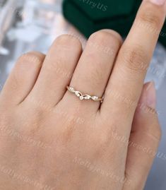 a woman's hand with a gold ring on it and the word love written in white