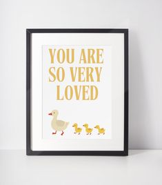 a framed print with ducks and the words you are so very loved in yellow letters