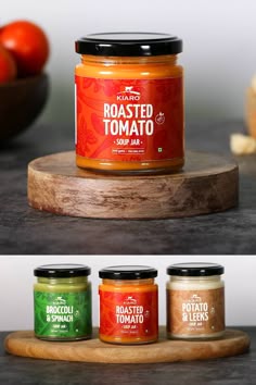 three jars of roasted tomato sauce sitting on top of a cutting board