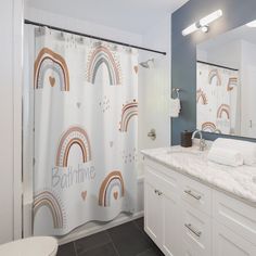 a bathroom with a shower curtain, sink and toilet