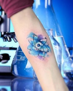 a person with a tattoo on their arm has an eyeball in the center of it