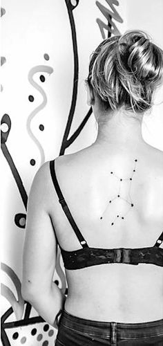 the back of a woman's bra with stars on her left shoulder and right arm