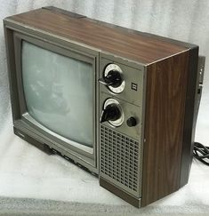 an old fashioned television sitting on top of a white sheet