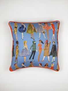 a blue pillow with an image of women in different dresses on the front and back