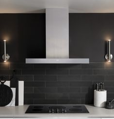 a stove top oven sitting inside of a kitchen next to a wall mounted range hood