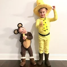 two children dressed in costumes standing next to each other