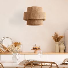 a dining room table with chairs, plates and utensils on top of it