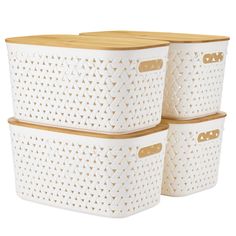 three white storage baskets with wooden handles