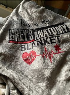 the grey's anatomy blanket is laying on top of a bed