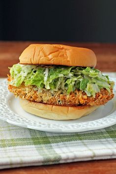 a chicken sandwich with lettuce on a plate