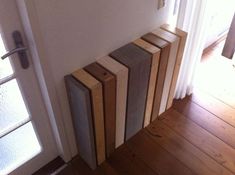 a stack of wooden boards sitting on top of a hard wood floor