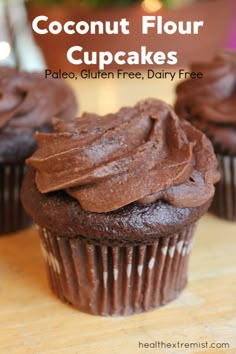 two chocolate cupcakes on a wooden table with text overlay that reads coconut flour cupcakes pale, gluen free, dairy free