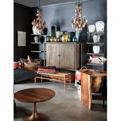 a living room filled with furniture and lots of vases on top of it's shelves