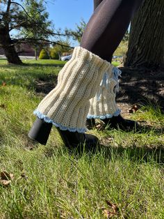 the legs of a woman wearing boots with knitted socks and leg warmers on