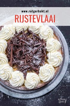 a chocolate cake topped with whipped cream and chocolate shavings