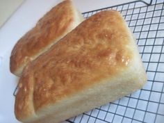 two loaves of bread sitting on top of a cooling rack