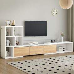 a flat screen tv sitting on top of a white entertainment center in a living room