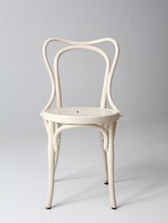 a white chair sitting on top of a white floor