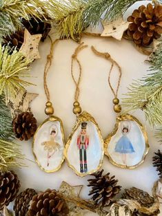 three christmas ornaments hanging from a pine tree