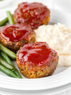 two meatloaf patties with mashed potatoes and green beans