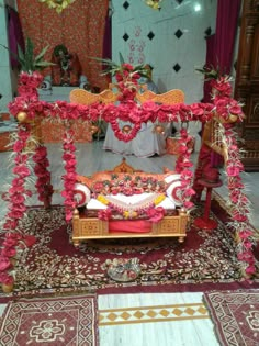 a bed covered in pink flowers on top of a rug