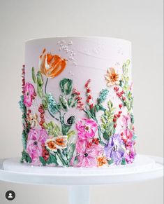 a white cake with flowers painted on it